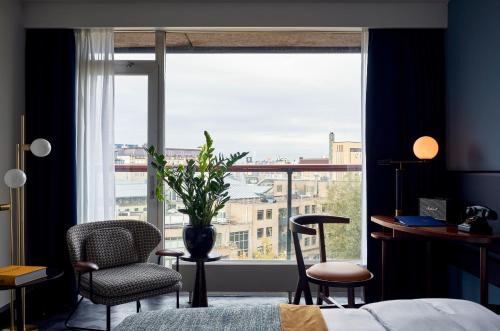 a bedroom with a large window with a view of a city at Park Centraal Amsterdam, part of Sircle Collection in Amsterdam