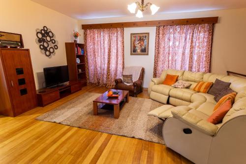 a living room with a couch and a table at Home Sweet Home in Ribeira Grande