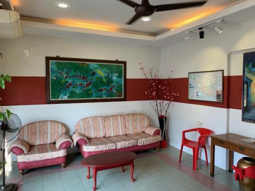 a living room with two couches and a table at Fairway Hotel in Malacca