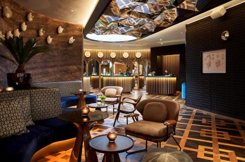 a lobby with couches and tables and a bar at Park Centraal Amsterdam in Amsterdam