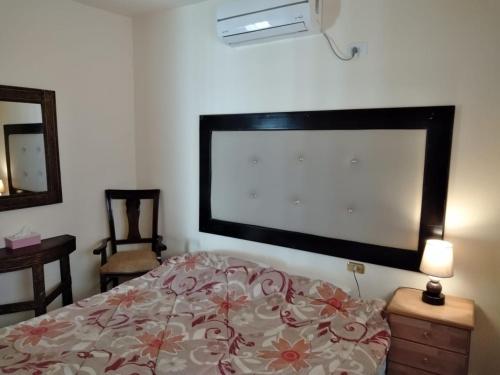 a bedroom with a bed with a large screen on the wall at Horizon in Wadi Musa
