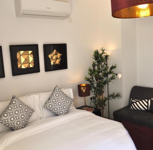 a living room with a white couch and a chair at Luxury Suite - Amazing Views & Lovely Garden in Salalah