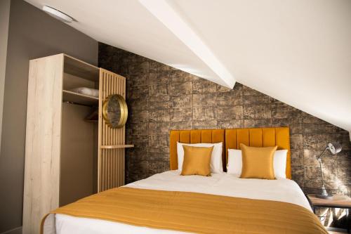 a bedroom with a large bed with yellow pillows at York Street Studios in Liverpool