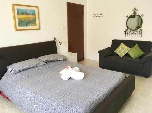 a bedroom with a bed with a stuffed animal on it at Pembroke Suites in Pembroke 