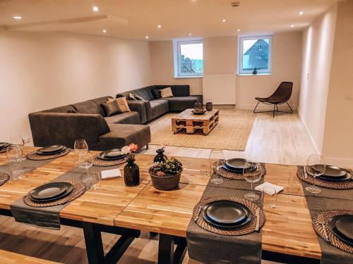 a living room with a table and a couch at Maison Demar in Gedinne