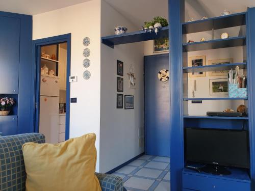 a living room with blue walls and a tv at Matteotti 134 in Sanremo
