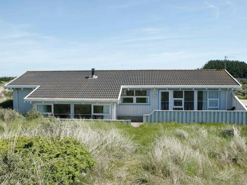 een huis met een dak op een strand bij 12 person holiday home in Hj rring in Lønstrup