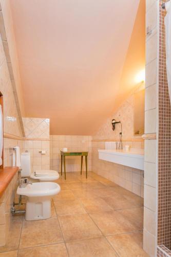 a bathroom with two toilets and a sink at Tenuta Elisabetta in Marina di Cecina