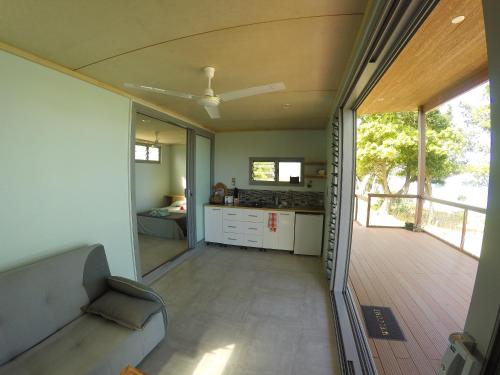 a kitchen and a living room with a deck at Aore Breeze in Luganville