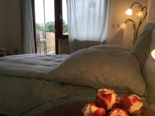 a bedroom with a bed and a table with flowers on it at Ruhige Ferienwohnung Beletage in Neuwied