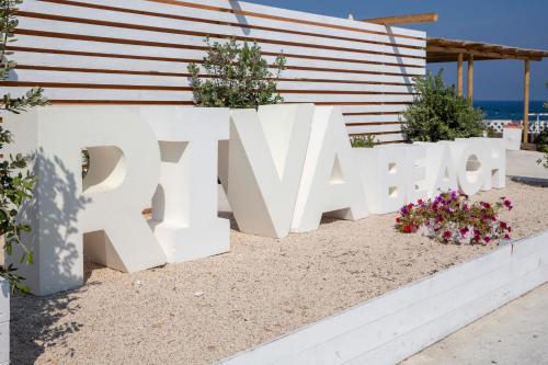 a large white sign that reads spa beach at Hotel Riva Del Sole in Giovinazzo