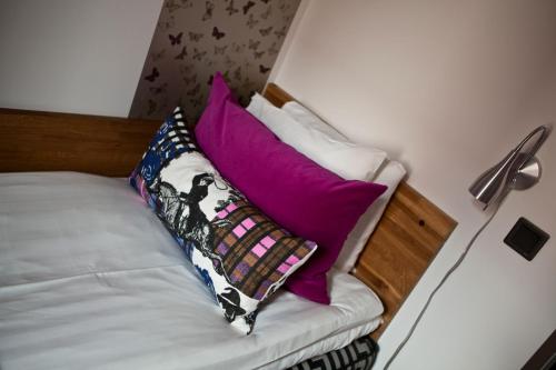 a bed with several pillows on top of it at Stora Hotellet Osby in Osby