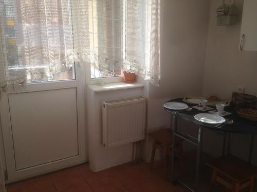 a room with a door and a window and a table at Apartment Mlynivs'ka 29 A in Rivne