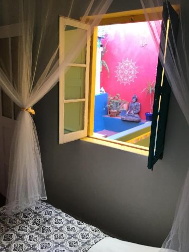a bedroom with a window in a room with a bed at Buddha Bee - 18 to 35 years old only in Lagos