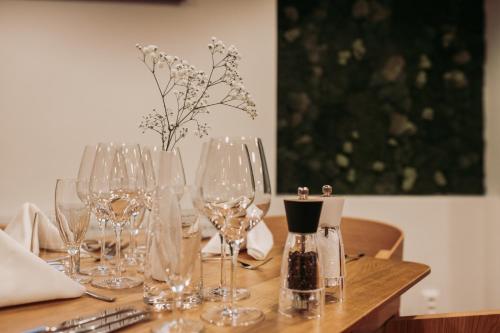 a wooden table with wine glasses on it at Hotel Aréna in Košice