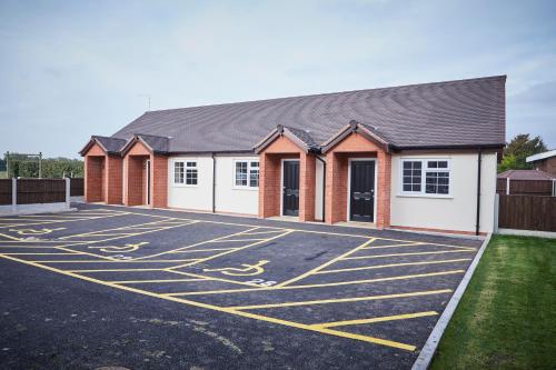 a parking lot in front of a building at The Appleby Inn Hotel in Appleby Magna