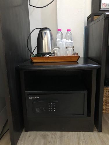 a table with bottles of water and a tea kettle at Wan Wan Place in Ao Nang Beach