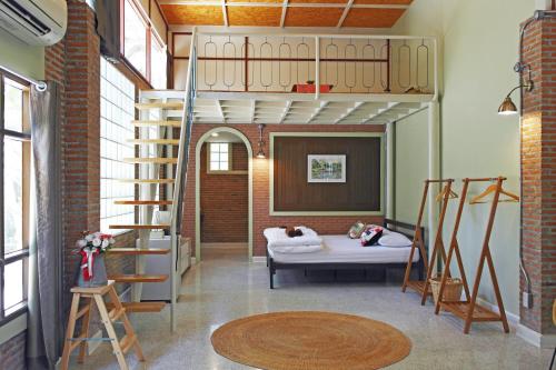 a bedroom with a bunk bed and a ladder at Baan Karm poo Uthaithani in Ban Nong Nam Khan