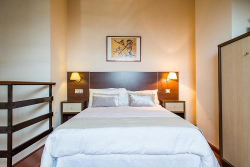 Säng eller sängar i ett rum på Apartamentos Dunas de Liencres