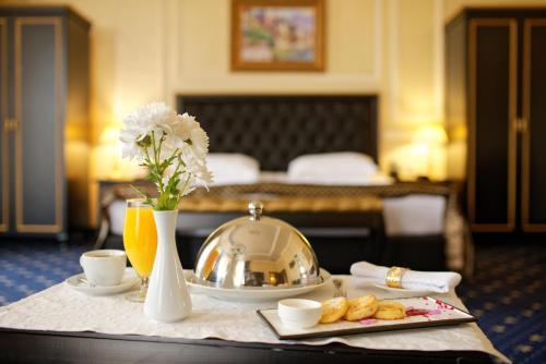 a table in a hotel room with a tray of food at Villa Le Premier - Maestro in Odesa