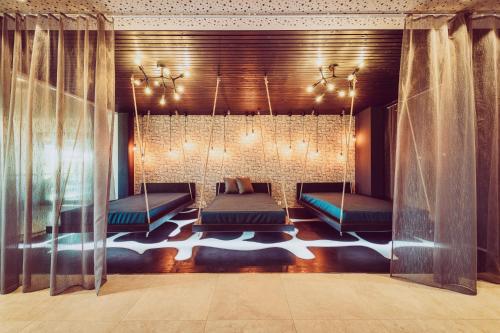 a bedroom with two beds and a chandelier at Landrefugium Obermüller 4,5 Sterne in Untergriesbach