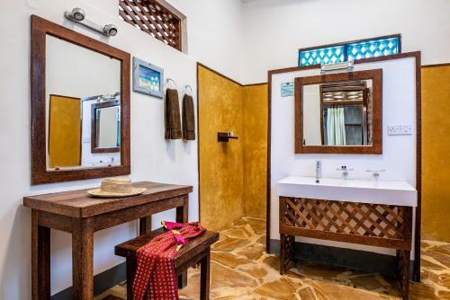 a bathroom with a sink and a mirror at Pongwe Beach Hotel in Pongwe