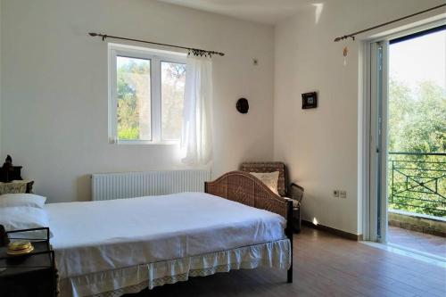 a bedroom with a bed and a large window at Fiorela maisonette in Sami
