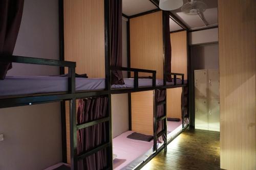 a group of bunk beds in a room at Wanderer In Melaka in Malacca