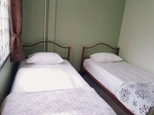 Cama o camas de una habitación en Baan U-Sabai บ้านอยู่สบาย