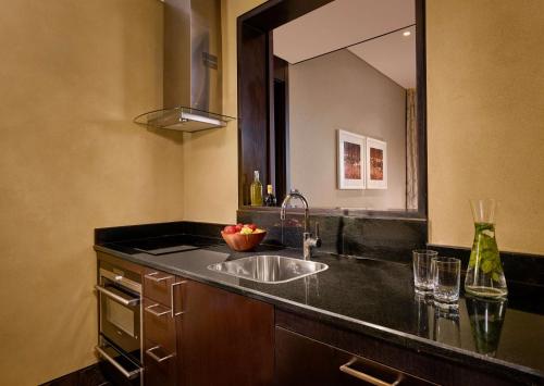 a bathroom with a sink and a large mirror at Grand Hyatt Abu Dhabi Hotel & Residences Emirates Pearl in Abu Dhabi