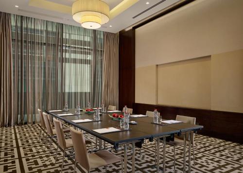 a conference room with a long table and chairs at Grand Hyatt Abu Dhabi Hotel & Residences Emirates Pearl in Abu Dhabi