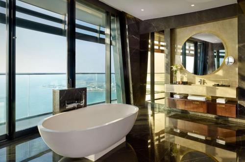 a bathroom with a tub and a large window at Grand Hyatt Abu Dhabi Hotel & Residences Emirates Pearl in Abu Dhabi