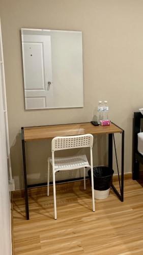 a dressing table with a chair and a mirror at 9TY hotel (ninety hotel) in Bangkok