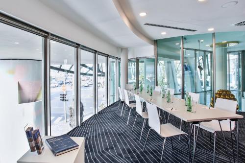 a conference room with a long table and chairs at Dancing House - Tančící dům hotel in Prague