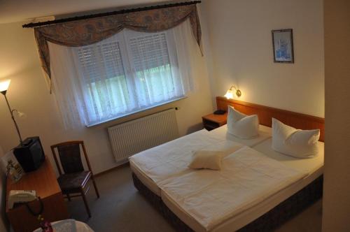 Postel nebo postele na pokoji v ubytování Hotel Kirchner