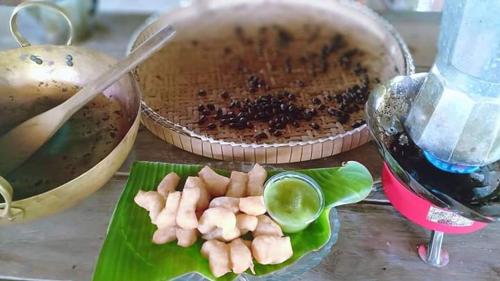 a table with a bowl of food and a cake at Ko Yao Noi Sabai Bungalows in Ko Yao Noi