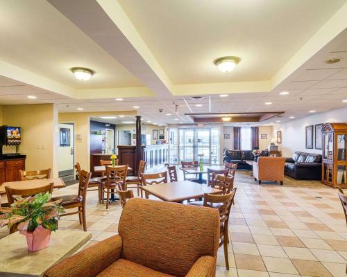 a lobby with tables and chairs and a living room at Mainstay Suites Dover in Dover