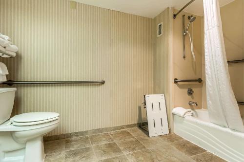 a bathroom with a toilet and a tub and a shower at Quality Inn Summerville-Charleston in Summerville