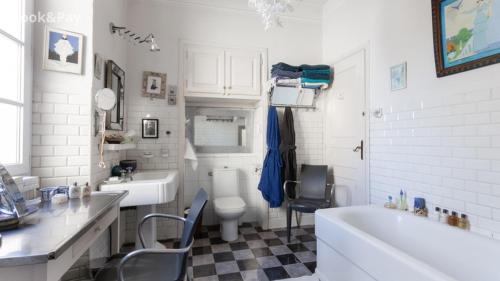 a bathroom with a sink and a toilet and a tub at La Marquise in Bastia
