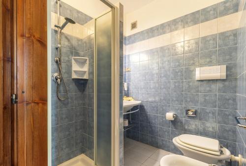 a bathroom with a shower and a toilet and a sink at Hotel Santa Maria in Santa Maria Navarrese