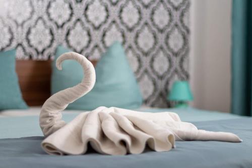 a towel shaped like a swan laying on a bed at Kőszeg Panzió in Kőszeg