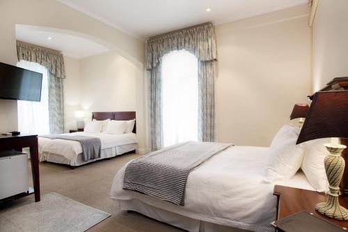 a bedroom with two beds and a large window at 39 on Church in Port Elizabeth