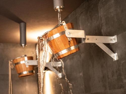 a shower with water coming out of a wooden faucet at Hotel TAMMEL in Jičín