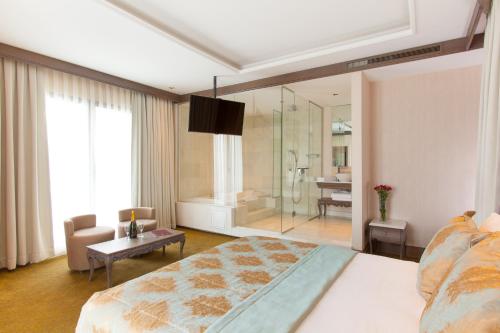 a bedroom with a large bed and a bathroom at AHC Ayasofya Hotel - Special Class in Istanbul