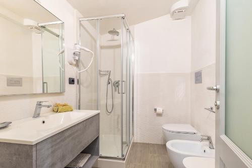 a bathroom with a shower and a sink and a toilet at Hotel Santa Maria in Santa Maria Navarrese