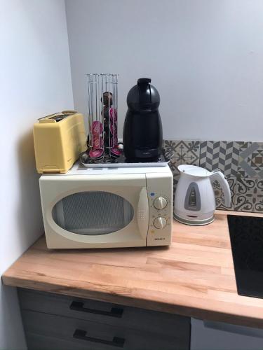 a microwave sitting on top of a counter at LE CHARME D OGNES in Ognes