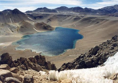 a large blue lake in the middle of a mountain at Don Remo in Villa Unión