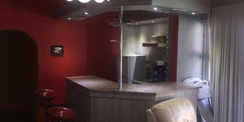 a bathroom with a counter and a red wall at DeTlous BnB in Empangeni
