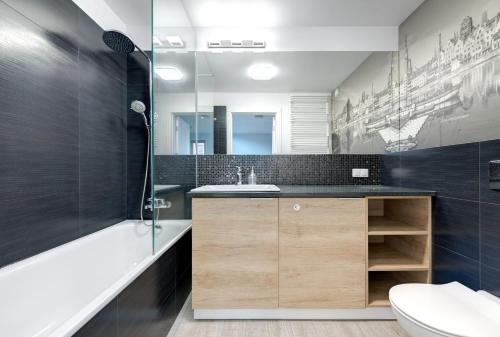 a bathroom with a sink and a toilet at 3 City Apartments - Waterlane Valhalla in Gdańsk