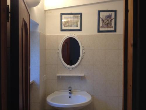 a bathroom with a sink and a mirror on the wall at Aria di Casa Country Resort in Alberobello